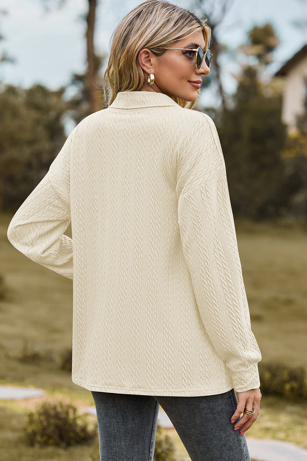 Cream textured polo-neck sweater with button detail and long sleeves.