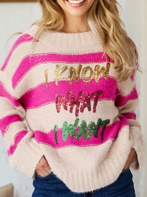 Bold sequin graphic colorblock knit sweater with crew neck and striped pattern.