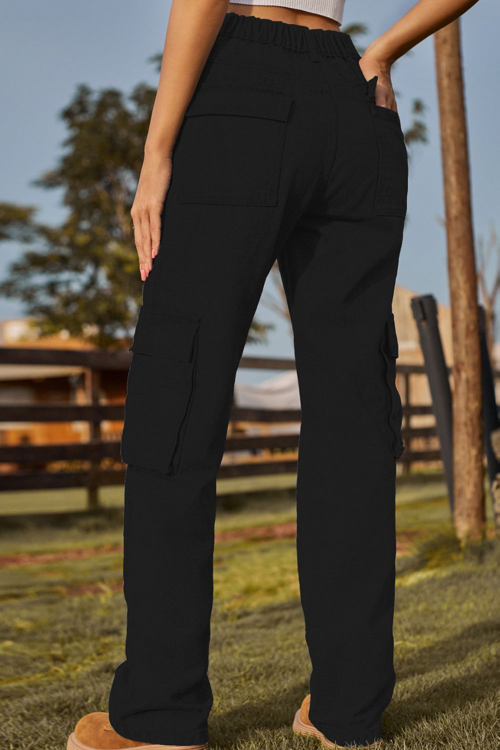 Black utility pocket denim cargo pants with a relaxed fit and elastic waistband.