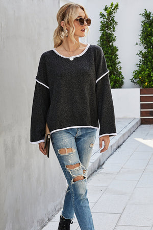 Oversized knit top in charcoal with white contrast trim and crew neck.