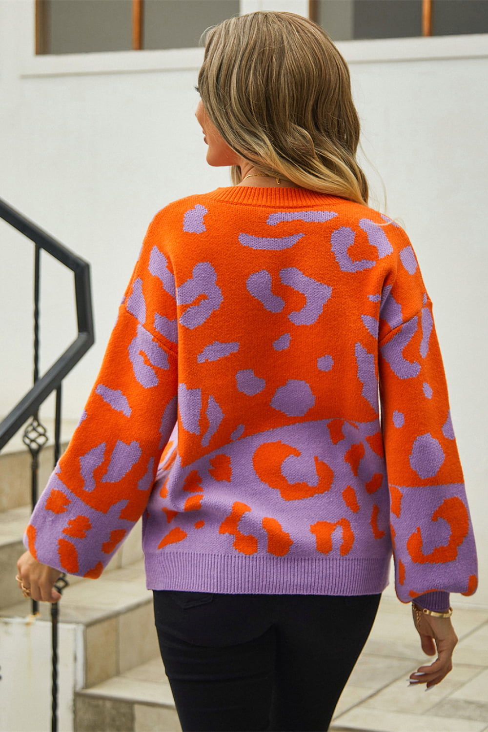 Colorblock leopard print acrylic sweater with balloon sleeves in orange and purple.