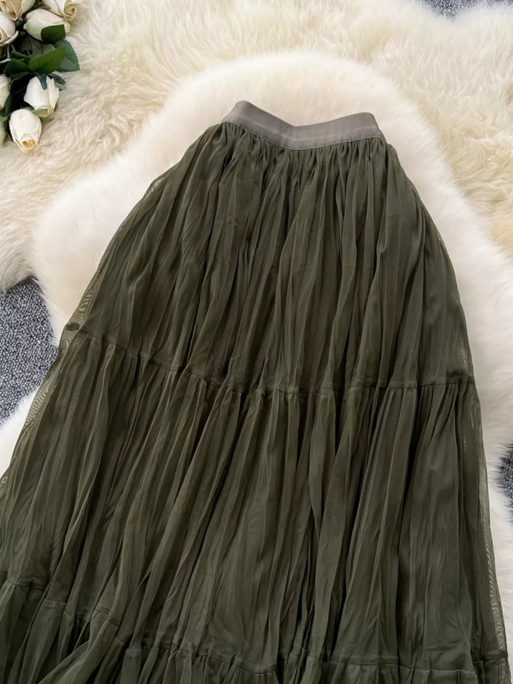 Elegant tiered tulle skirt in army green with a ruffled hem and elastic waistband.