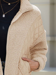 Camel quilted jacket with sherpa panels and zip closure.