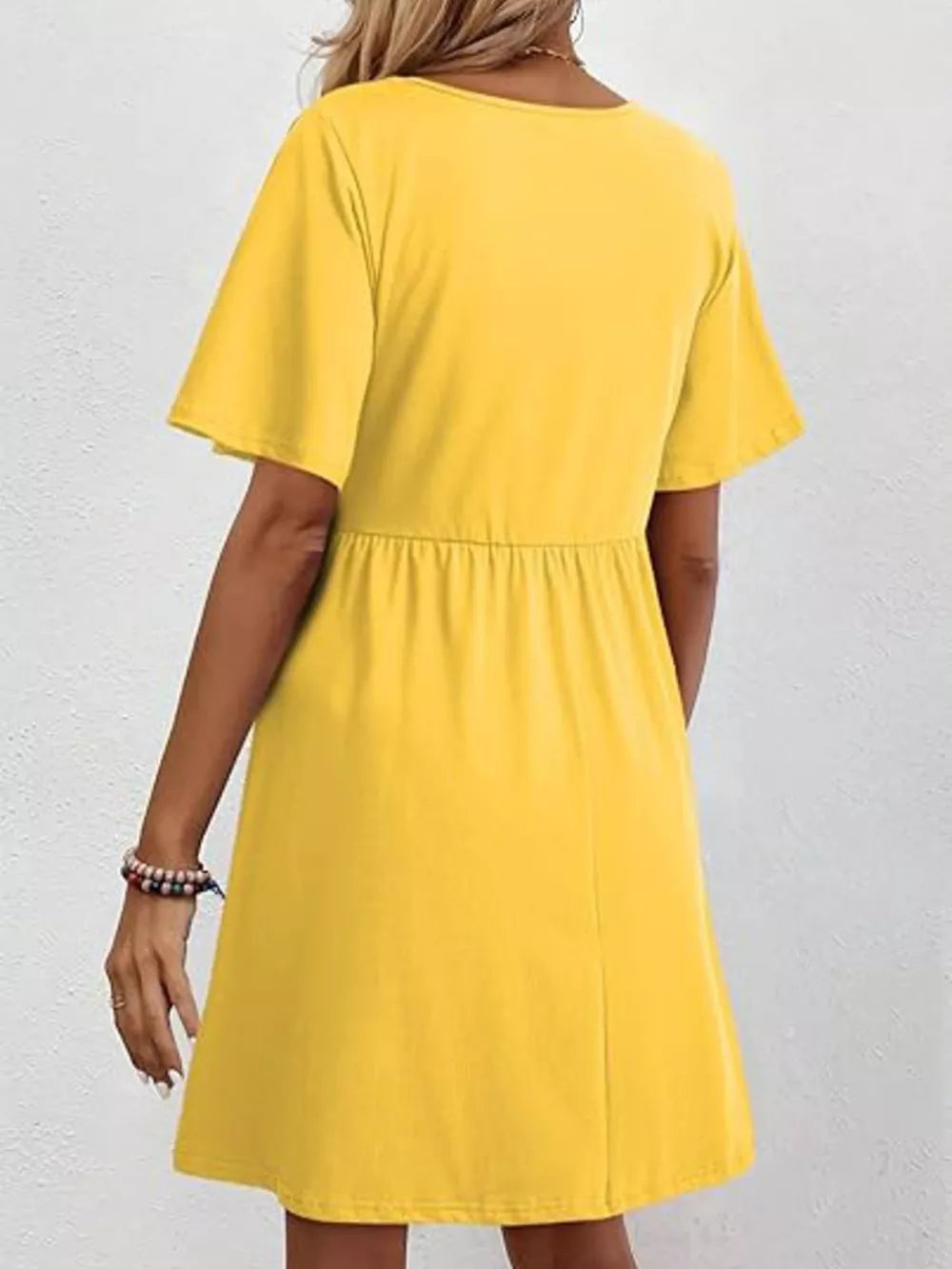 Yellow cotton v-neck mini dress with short sleeves and elastic waist