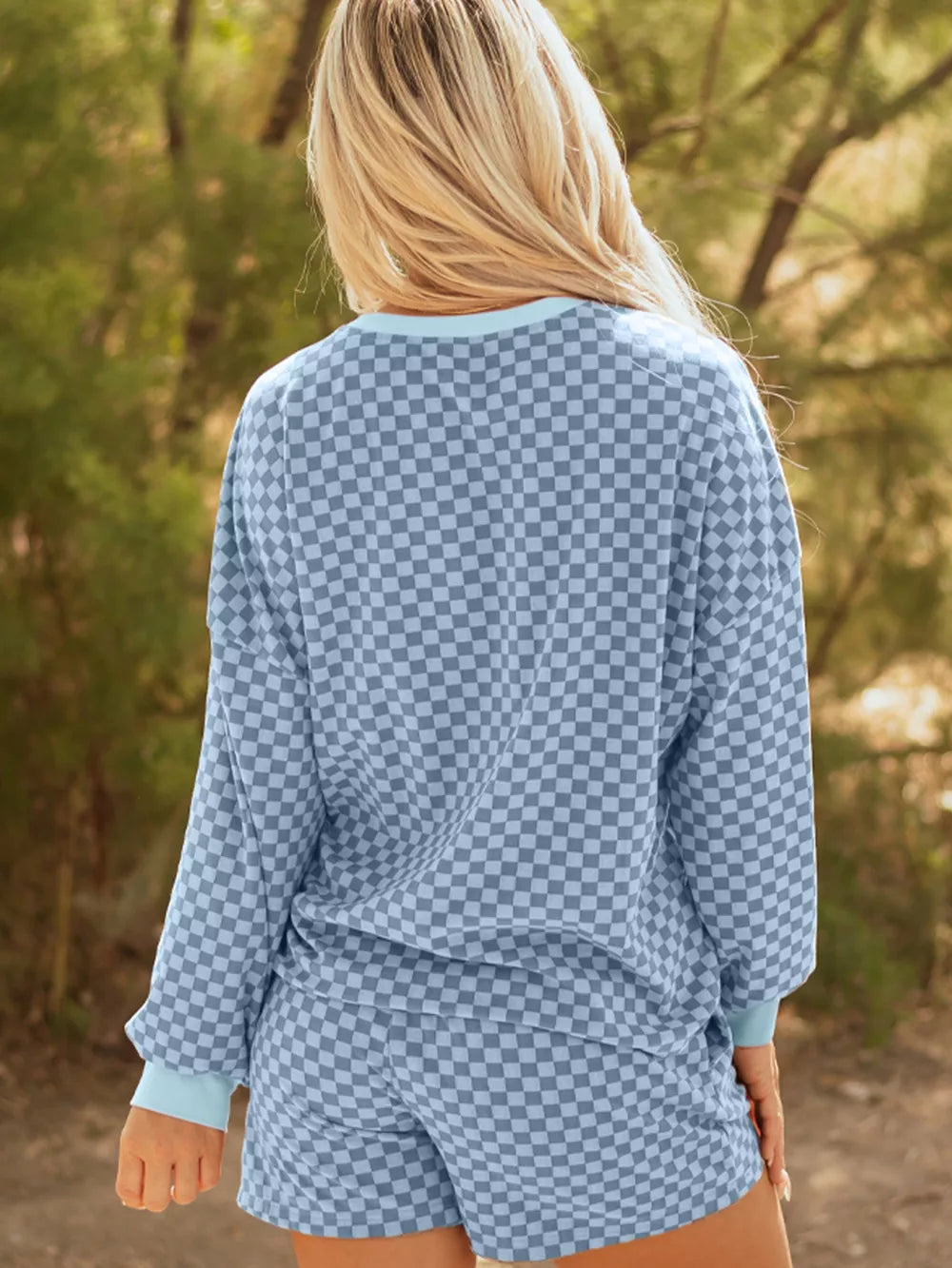 Light blue checkerboard loungewear set with crewneck pullover and shorts.