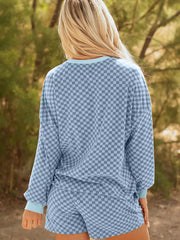 Light blue checkerboard loungewear set with crewneck pullover and shorts.