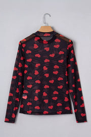 Black sheer mesh long sleeve top with all-over red heart print and mock neck.