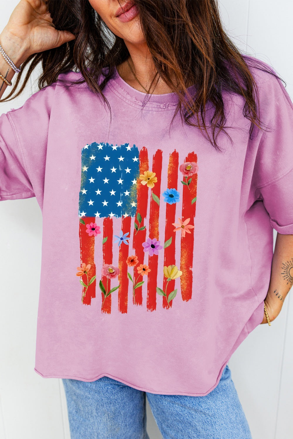 Floral American flag graphic cotton t-shirt with crew neck and distressed details.