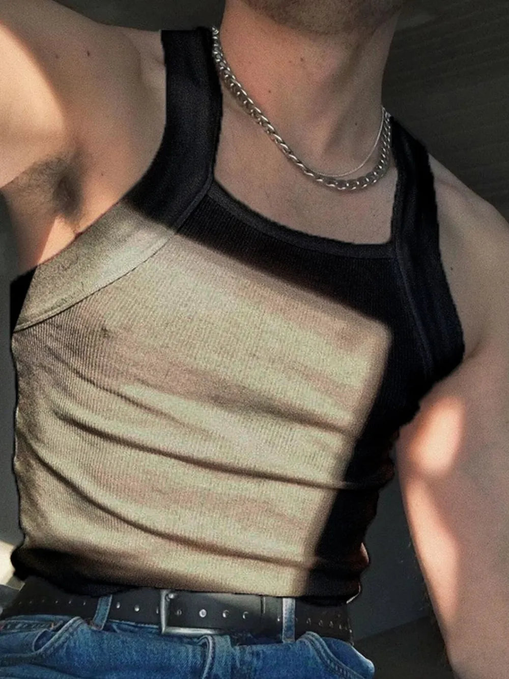 Black ribbed tank top with square neckline and chain necklace