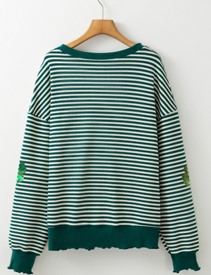 Dark green and white striped boatneck pullover with clover appliqué detail.