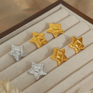 Textured celestial star stud earrings in gold and silver.