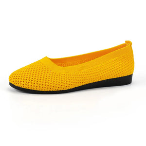 Yellow breathable knit ballet flats with a black sole and a rounded toe.