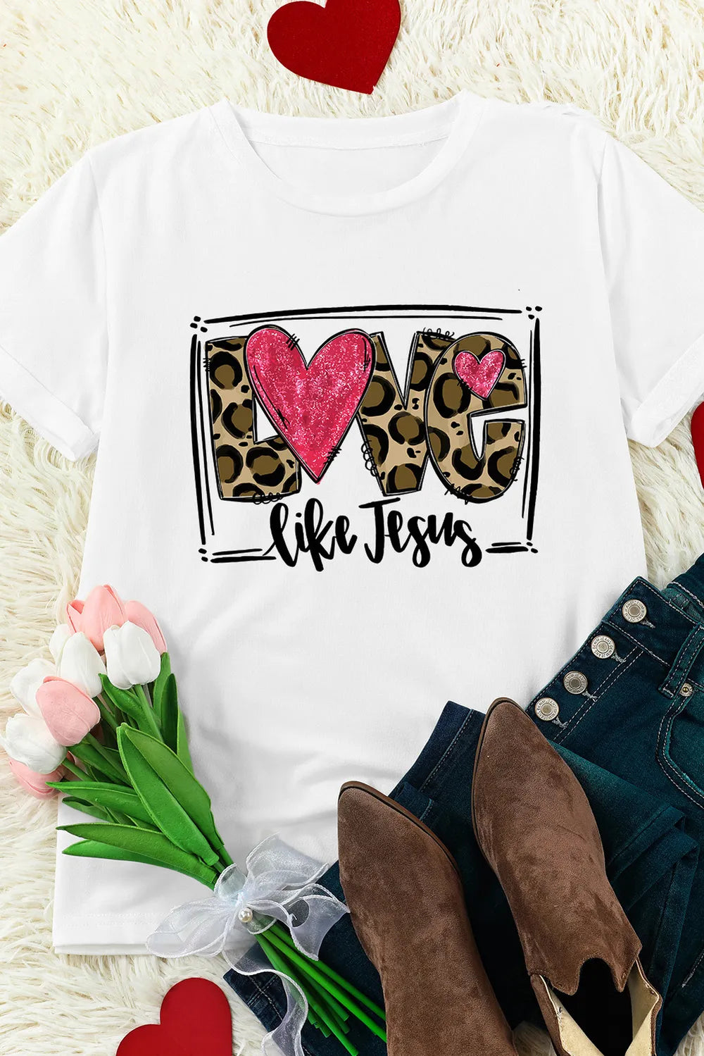White graphic tee with leopard print "LOVE" and "like Jesus" text, featuring pink hearts.