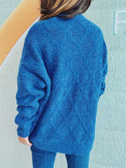 Blue sparkle knit relaxed fit sweater with textured pattern and long sleeves.