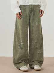 Distressed wide-leg denim trousers in green with acid wash and ripped details.