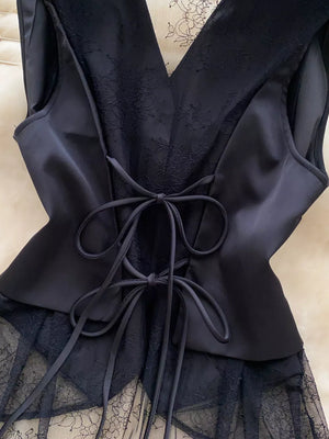 Black lace-embellished button-down vest coat with satin panels and lace-up back detail.