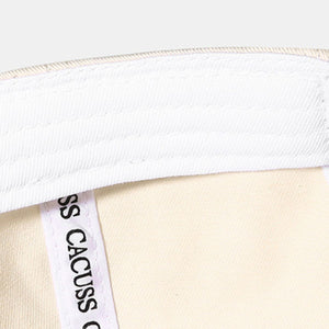 Off-white distressed cotton baseball cap interior detail with white stitching and label.