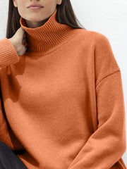 Orange ribbed turtleneck sweater with relaxed fit and long sleeves.