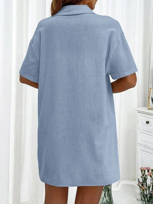 Light blue linen shirt with short sleeves and collar, shown from the back.