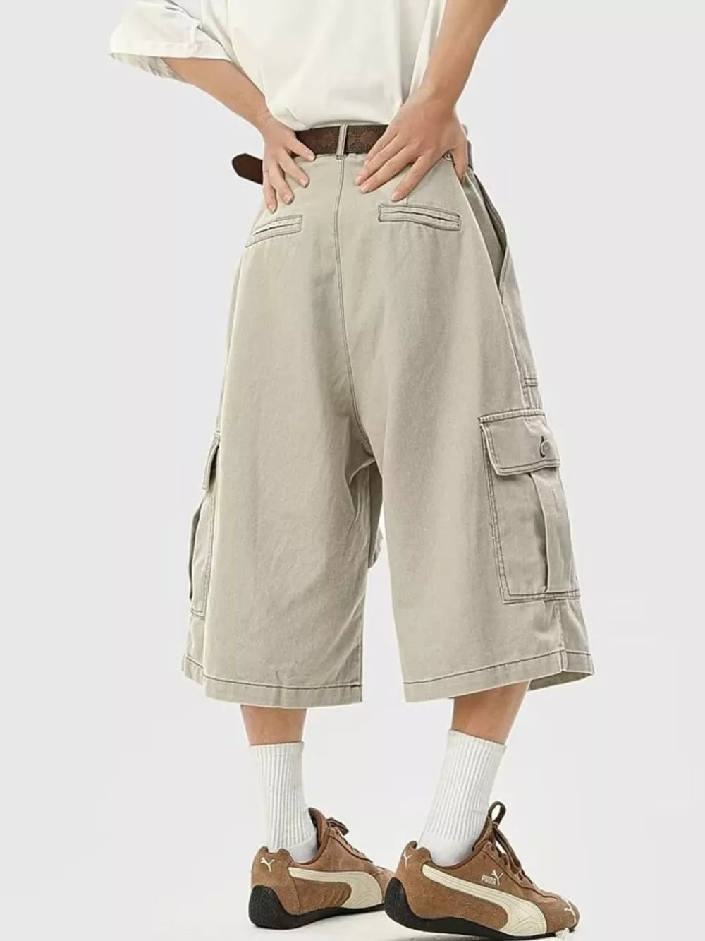 Relaxed fit khaki cargo sweatpants with cropped length and multiple pockets.