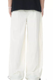 Men's off-white casual flowing wide-leg sweatpants with drawstring cuffs.