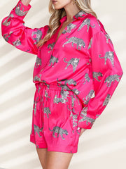Hot pink silk pajama set with leopard print, button-up shirt and drawstring shorts.