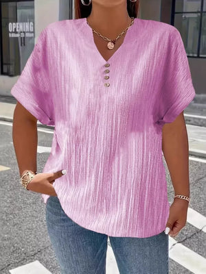 Light purple textured v-neck t-shirt with decorative buttons and cuffed sleeves.
