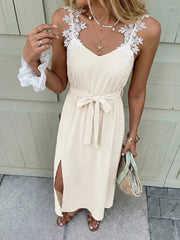Beige lace-trimmed V-neck maxi dress with tie waist and side slit.