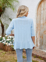Pastel blue eyelet cardigan with 3/4 sleeves and a ruffled hem.