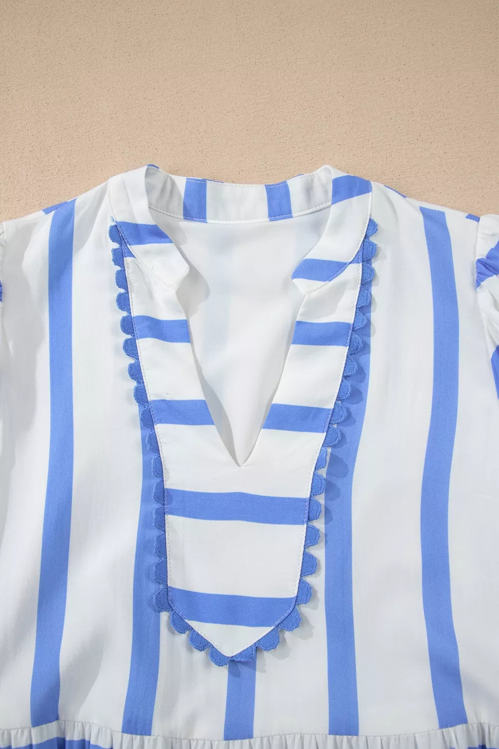 Tiered dress with blue and white stripes, V-neck, and ricrac trim.