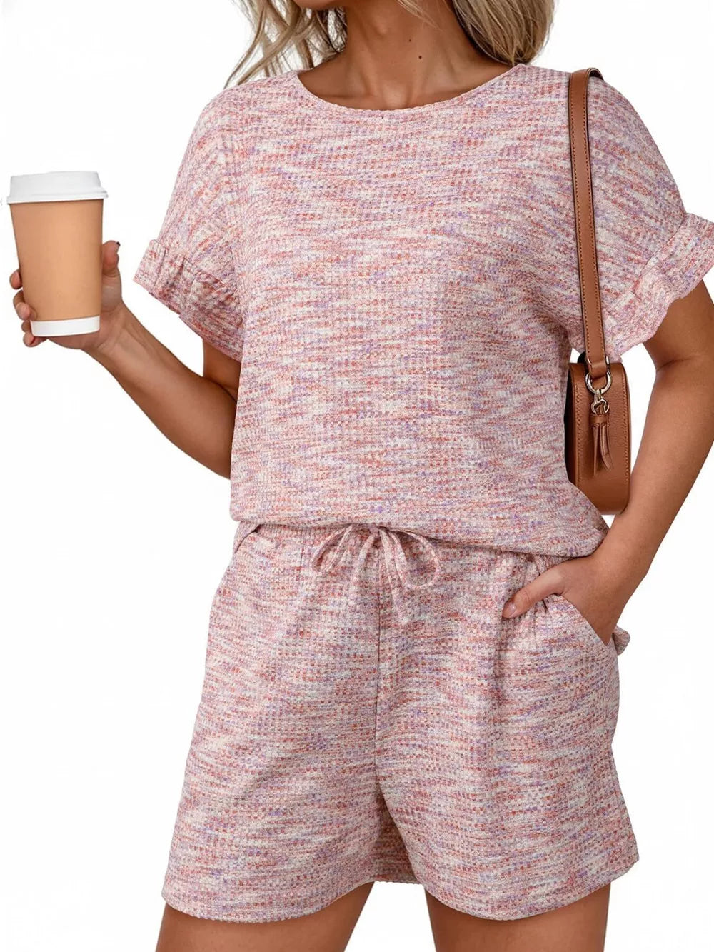 Pink ruffled sleeve two-piece set with drawstring shorts and textured fabric.