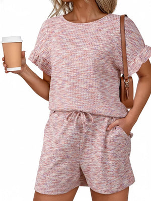 Pink ruffled sleeve two-piece set with drawstring shorts and textured fabric.