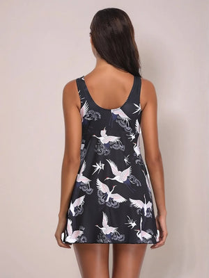 Black swimdress with crane print, A-line cut, scoop neck, sleeveless.