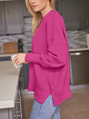 Ribbed-knit relaxed fit sweater in deep rose with dropped shoulders and a curved hem.