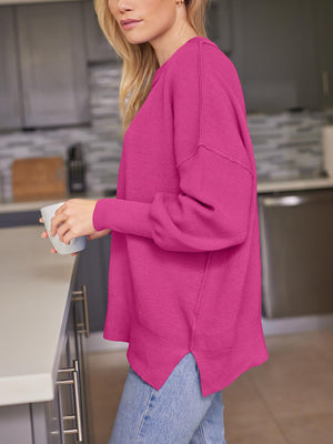 Ribbed-knit relaxed fit sweater in deep rose with dropped shoulders and a curved hem.