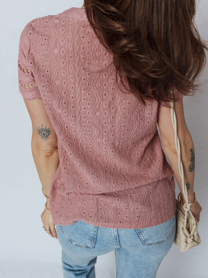 Rose pink eyelet embroidered short-sleeve blouse with a scalloped hem.