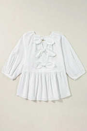 White babydoll blouse with back bow details and peplum hem