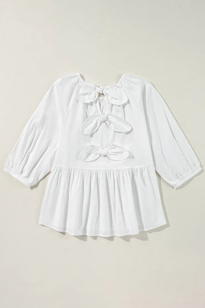 White babydoll blouse with back bow details and peplum hem