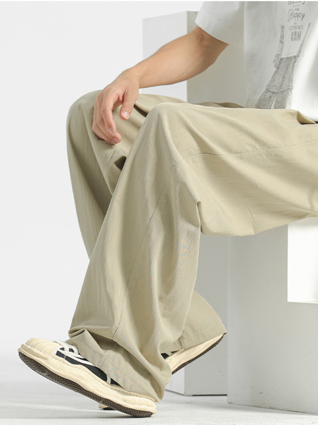 Beige sweatpants with a relaxed fit and visible stitching details.