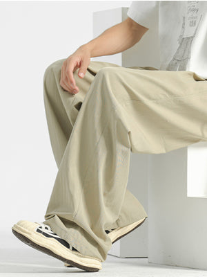 Beige sweatpants with a relaxed fit and visible stitching details.