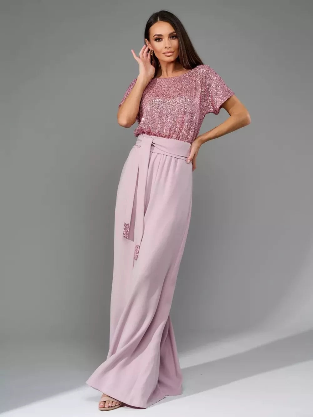 Pink sequin short sleeve wide-leg jumpsuit with tie waist and sequin detail on tie.