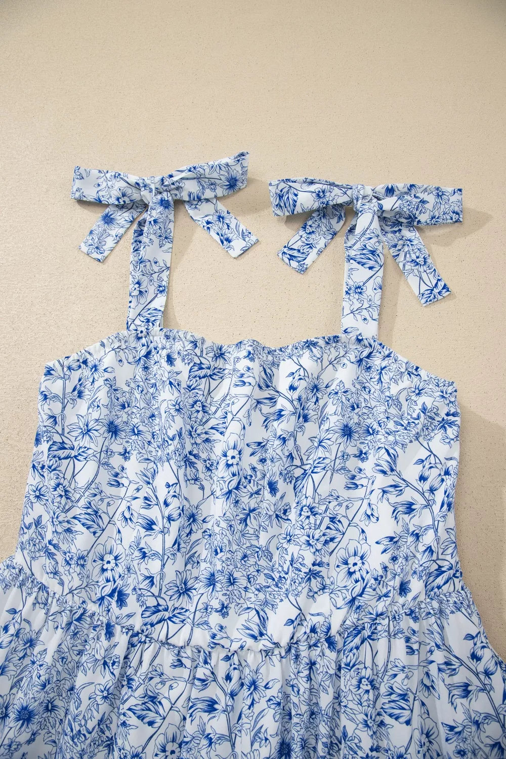 Maxi dress with blue floral print and tie shoulder straps