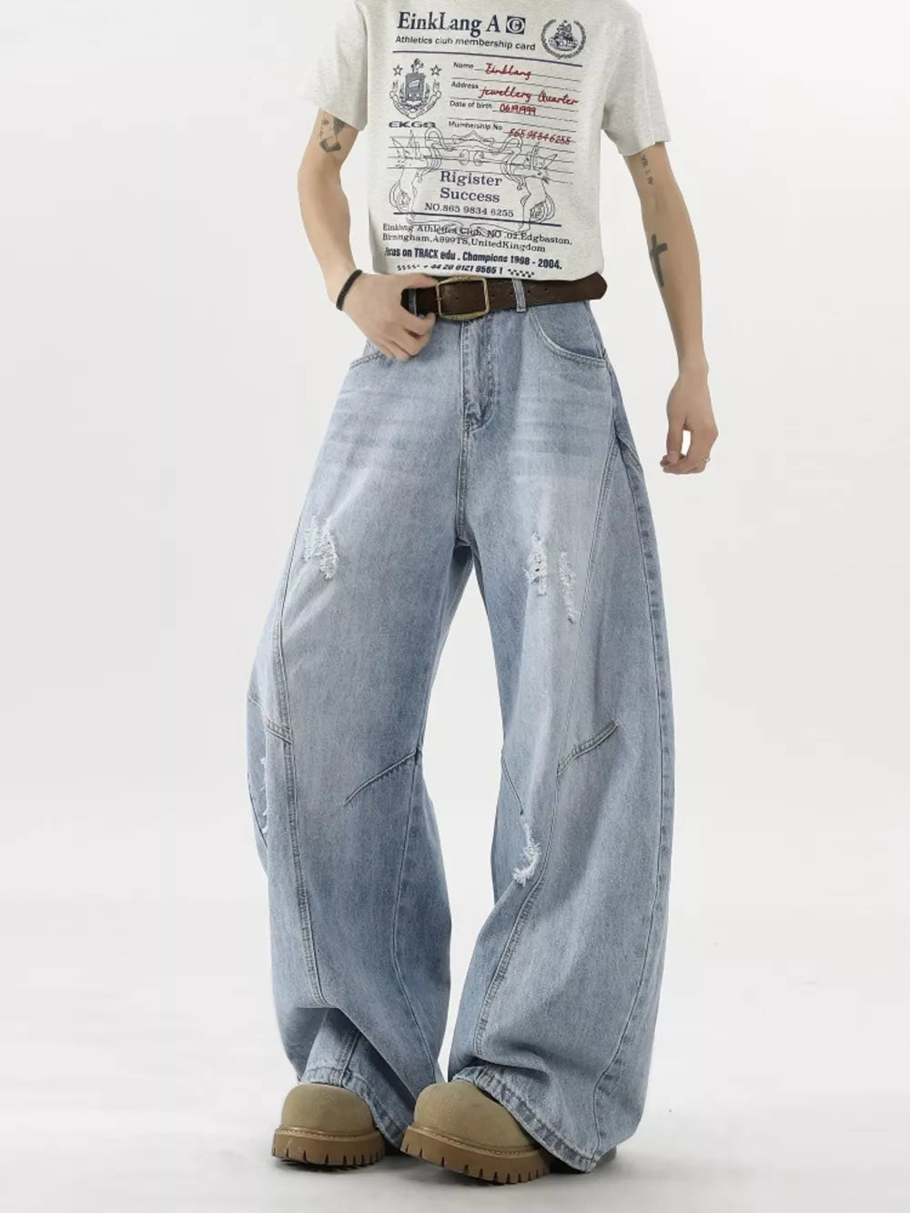 Distressed light blue wide-leg denim jeans with belt