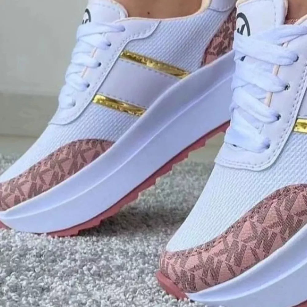 Chic round toe platform sneakers in white with pink logo accents and gold stripes.