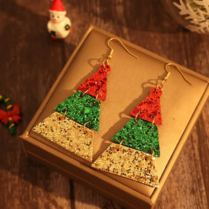 Festive glitter tiered Christmas tree earrings in red, green, and gold.
