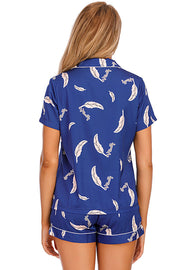 Royal blue satin pajama set with feather print, short sleeves, and white piping.
