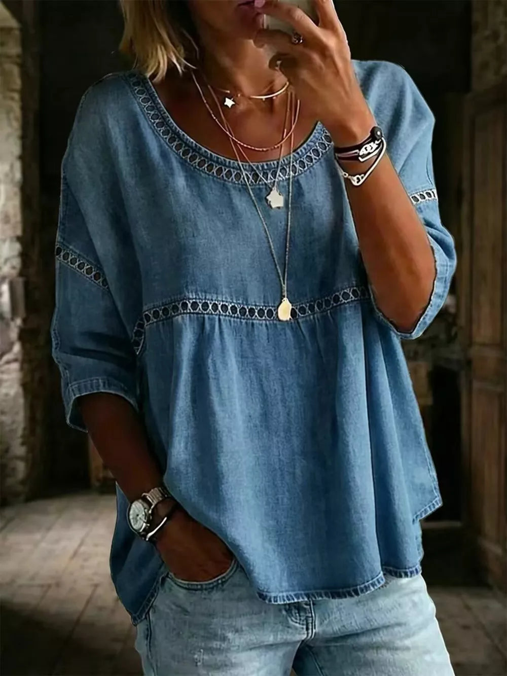 Blue maternity t-shirt with openwork trim and round neckline.