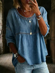 Blue maternity t-shirt with openwork trim and round neckline.