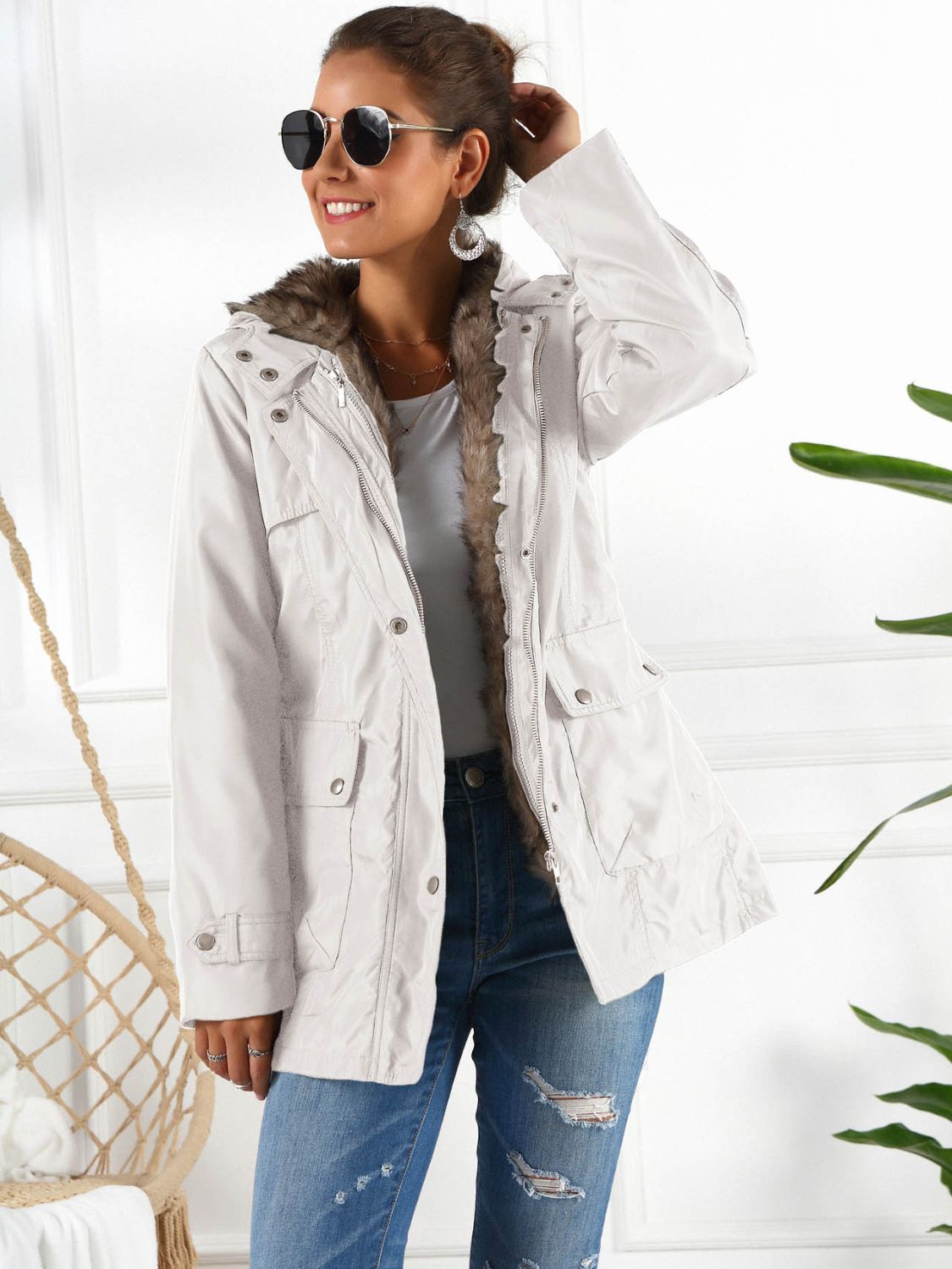 White belted utility parka with faux fur trim and hood, featuring multiple pockets.