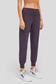 Plum purple jogger fit performance trousers with pockets and cuffed ankles.